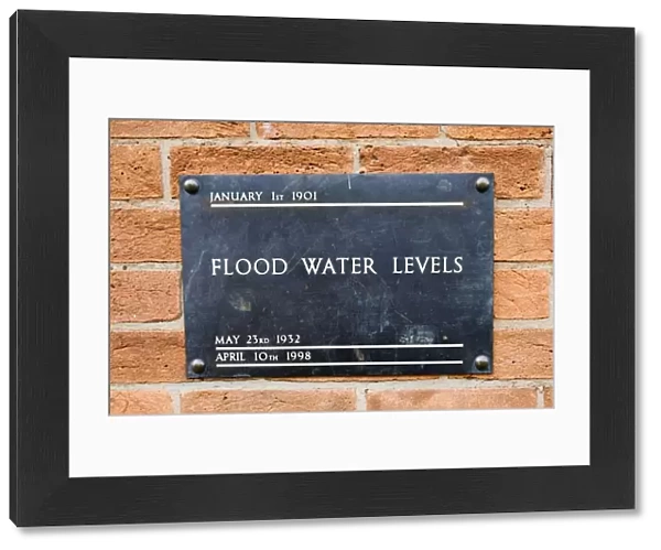 UK - Brass plate displaying high flood levels on wall of house in Stratford upon Avon