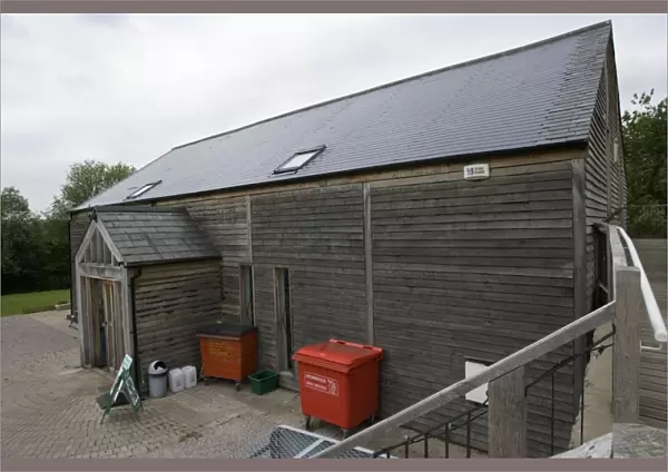 Photovoltaic shingle tile roof - on Brockweir & Hewelsfield Village Shop Forest of Dean UK. Almost the entire roof is photovolatic shingles with just a small strip of ordinary tiles on each side