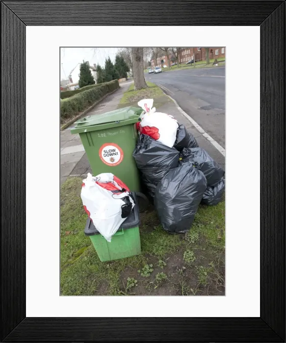Framed Print : Green wheelie bin overflowing with domestic rubbish awaiting collection Cheltenham UK Framed Print : Green wheelie bin overflowing with domestic rubbish awaiting collection Cheltenham UK