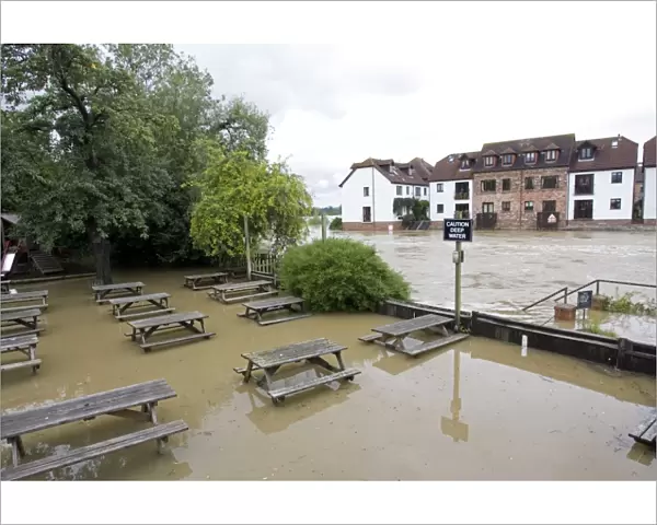 Submerged picnic tables in pub alongside River Avon in flood from Mythe Bridge Tewkesbury Gloucestershire UK during unprecedented flooding of Rivons Avon and Severn above 1947 level