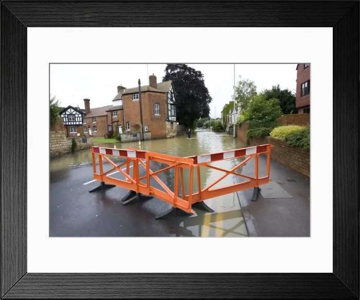 Framed Print : Woman walking along flooded road into Tewkesbury near Abbey Gloucestershire UK. Level of Rivers Avon and Severn almost at 1947 levels on July 21 2007 Framed Print : Woman walking along flooded road into Tewkesbury near Abbey Gloucestershire UK. Level of Rivers Avon and Severn almost at 1947 levels on July 21 2007
