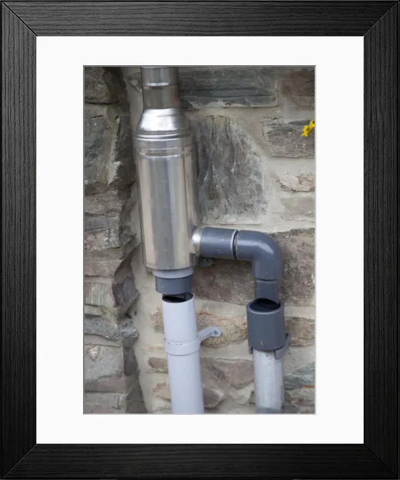Framed Print : Wisey stainless steel rain water diverter and filter installed in downpipe of eco house UK Framed Print : Wisey stainless steel rain water diverter and filter installed in downpipe of eco house UK