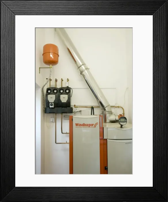 Framed Print : Windhager Austrian wood pellet fired domestic biomass boiler produces heat for thermal store using small wood pellets supplied from a large external hopper installed in small cottage Cotswolds UK Framed Print : Windhager Austrian wood pellet fired domestic biomass boiler produces heat for thermal store using small wood pellets supplied from a large external hopper installed in small cottage Cotswolds UK