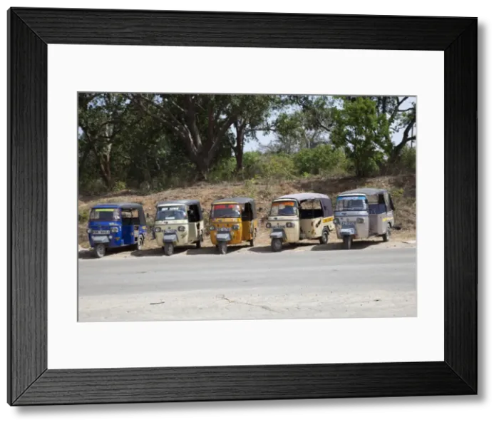 Framed Print : Line of Tuk-Tuk three wheeled motorised rickshaw taxis waiting for passengers Kilifi - Kenya Framed Print : Line of Tuk-Tuk three wheeled motorised rickshaw taxis waiting for passengers Kilifi - Kenya
