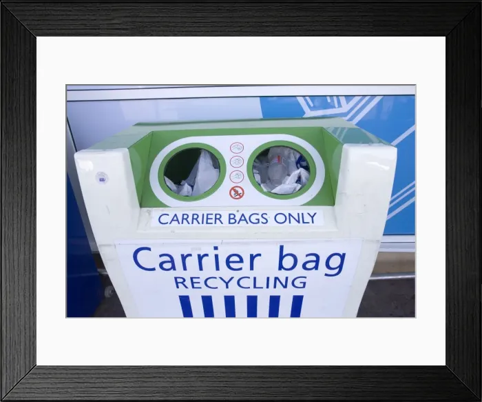 Framed Print : Carrier bag recycling container outside Tesco food store for disposing of plastic bags. Tesco does not charge customers for plastic carrier bags but has recently changed to using biodegrradable plastic Framed Print : Carrier bag recycling container outside Tesco food store for disposing of plastic bags. Tesco does not charge customers for plastic carrier bags but has recently changed to using biodegrradable plastic