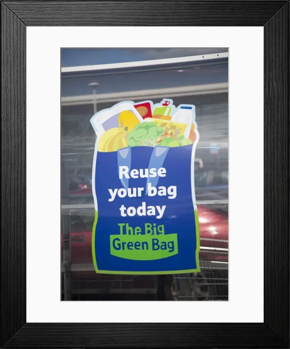 Framed Print : Sign encouraging use of reusable bags Tesco - Evesham - UK Framed Print : Sign encouraging use of reusable bags Tesco - Evesham - UK