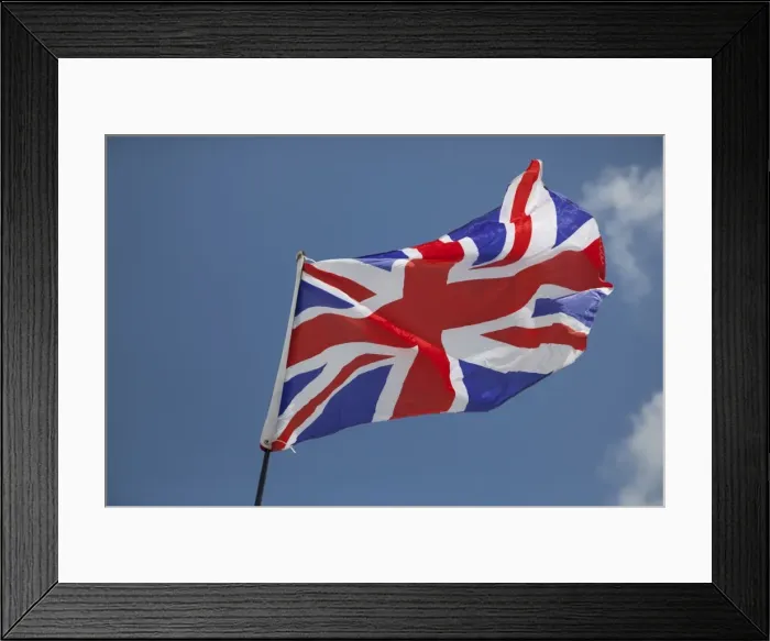 Framed Print : Union Jack flag - flying in light breeze against blue sky - UK Framed Print : Union Jack flag - flying in light breeze against blue sky - UK