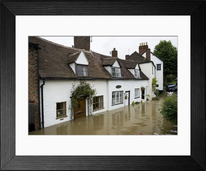 Framed Print : Flooding - Baling water from flooded riverside cottages near Mythe Bridge Tewkesbury Gloucestershire UK Level of Rivers Avon and Severn almost at 1947 levels on July 21 2007