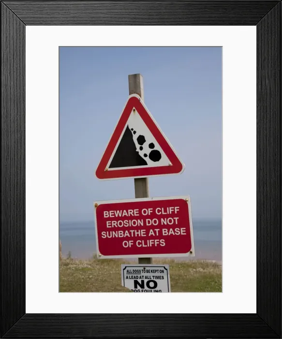 Framed Print : Warning sign coastal erosion on cliffs East Newton East Riding of Yorkshire UK