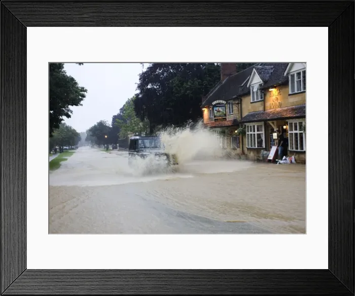 Framed Print : Flooding - Landrover driving through torrents of flood water in high street Broadway Gloucestershire UK July 21 2007 Framed Print : Flooding - Landrover driving through torrents of flood water in high street Broadway Gloucestershire UK July 21 2007