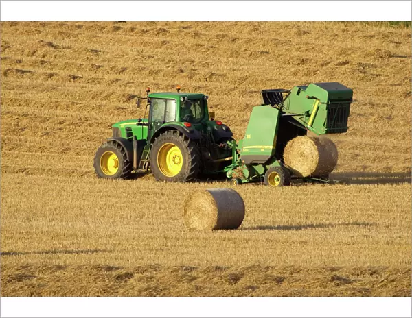 Tractor stopping to allow hay bale making machine to release bale of hay - September - Staffordshire - England