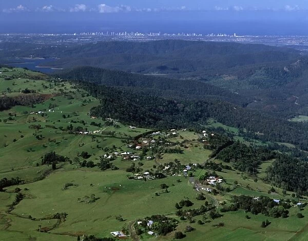 Aerial - Agricultural land & distant Gold Coast high-rises near Beechmont, Queensland JPF48697