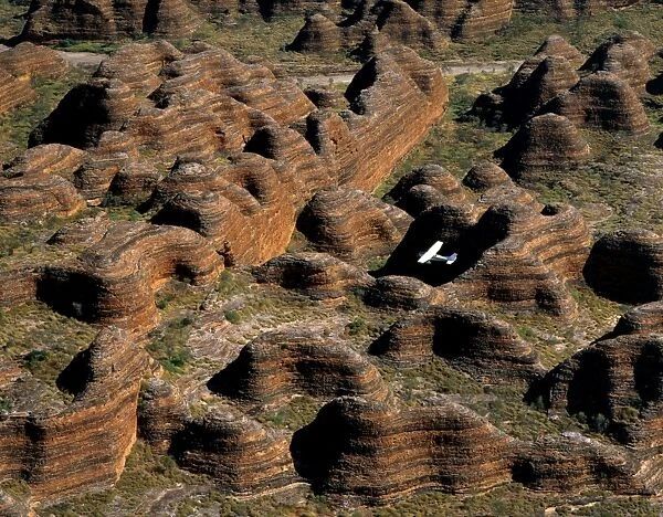 Aerial - Bungle Bungle Range & plane Sandstone range formed 400 million years ago from layered sediments washed into a rift valley. Eroded into ‘beehive formations and deep canyon-like valleys, Purnululu National Park