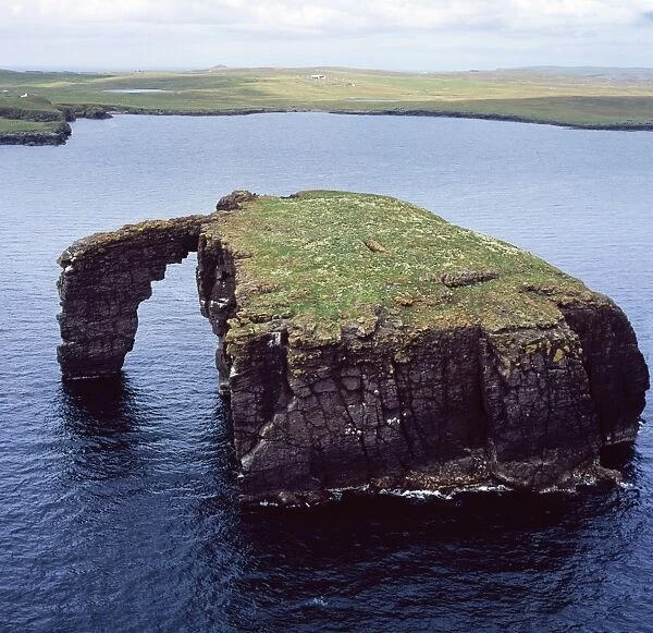Aerial image of Scotland, UK: Dore Holm, a small islet with a natural arch, off the south coast of Esha Ness, in the west of Mainland, Shetland
