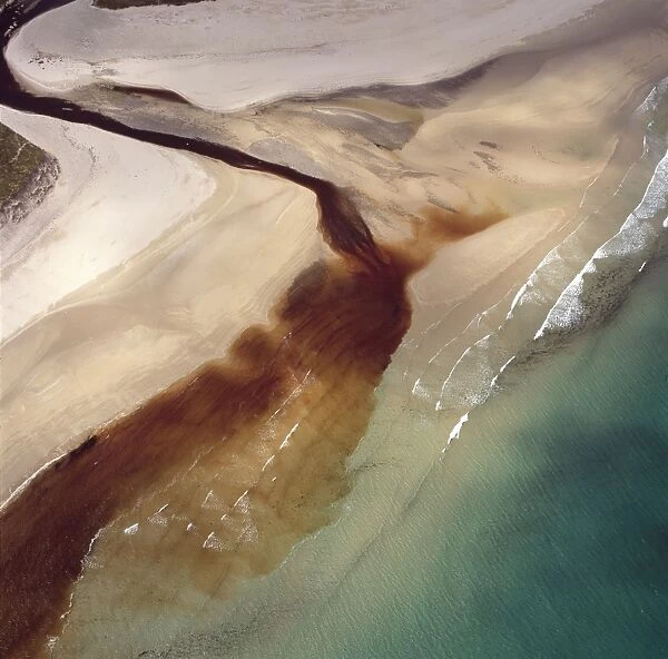 Aerial image of Scotland, UK: Sinclair's Bay, south of Keiss, north-east Caithness, east coast of Scotland. Water of the Burn of Lyth flows through Loch of Wester