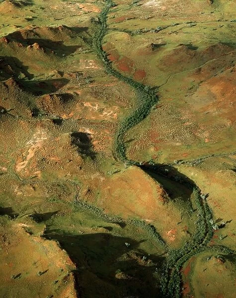 Aerial of land rich in iron oxides - the Pilbara seabed rose to form one of Earth's first permanent land masses about 3. 5 billion yeras ago. Summits are layered where hard rock has resisted erosion - Hamersley Range, Pilbara region