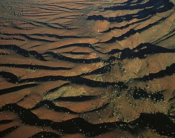 Aerial: south-western side of Hamersley Range the Pilbara seabed rose to form one of Earth's first permanent land masses about 3. 5 billion years ago. The area shown is rich in iron oxides, Pilbara region, Western Australia JPF44350