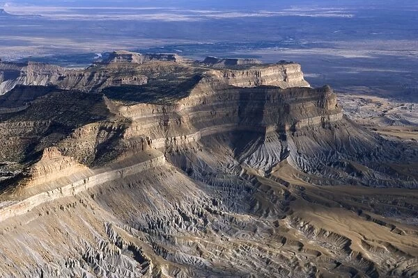 Aerial view of the Book Cliffs - north of the town of Green River, Utah; looking south towards Green River. The cliffs are carved into the Mancos Shale (marine deposits, grey talus slope), capped by sandstone of the Mesaverde Group