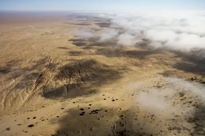 Framed Print : Aerial view of mist rolling in from the cold Atlantic Ocean over the Namib Desert Plains - Namib Desert - Namibia - Africa Framed Print : Aerial view of mist rolling in from the cold Atlantic Ocean over the Namib Desert Plains - Namib Desert - Namibia - Africa