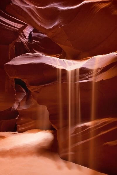 Antelope Canyon - swirling Navajo sandstone - with sand falling from the desert above into the slot canyon's crack - Antelope Canyon Navajo Tribal Park - Arizona - USA