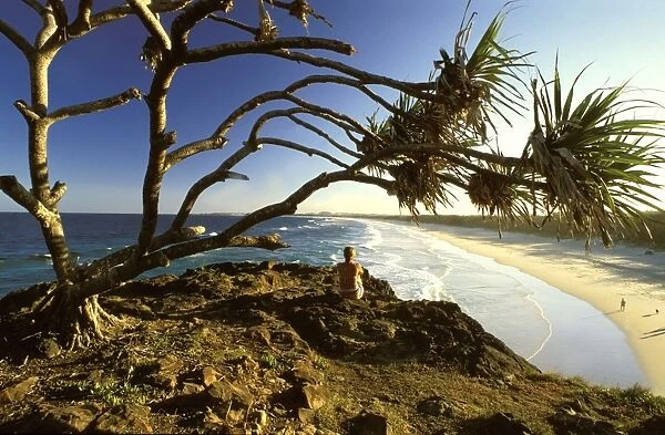 Australia - Beachgoer enjoying landscape of the open surf beach. The international tourist industry in the region relies on the good condition of the mountains, coast, islands & waters. near Fingal Head, north coast New South Wales