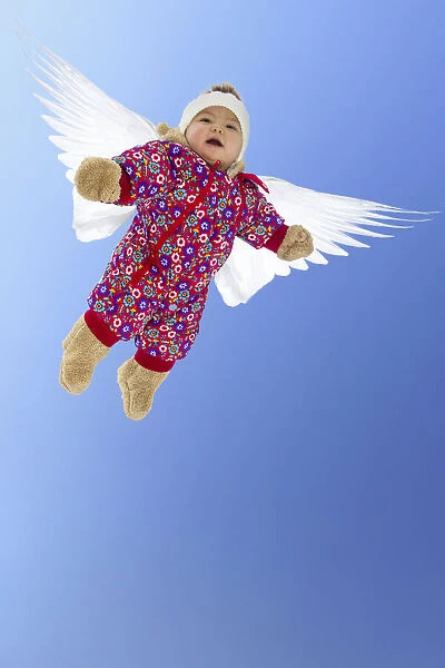Baby girl with wings, flying angel. model released