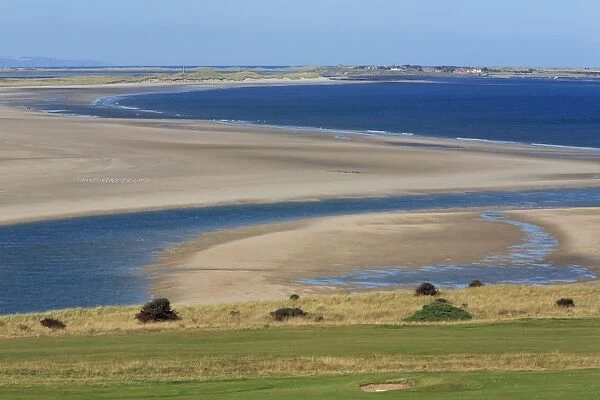Bamburgh Castle Golf Course - looking northwards towards Budle Bay wildfowl reserve and lindisfarne village on Holy Island, Northumberland National Park, England