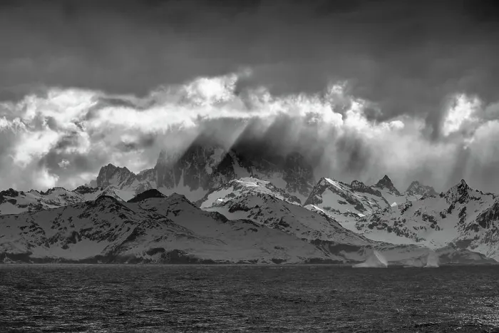 Framed Print : Black and white of South Georgia Island. Opening in clouds and Virga reveal the mountainous and glaciated landscape. Date: 18-10-2019 Framed Print : Black and white of South Georgia Island. Opening in clouds and Virga reveal the mountainous and glaciated landscape. Date: 18-10-2019