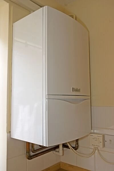 Boiler - vaillant EcoTec modern combination or compact combi boiler installed in small flat produces instant hot water UK