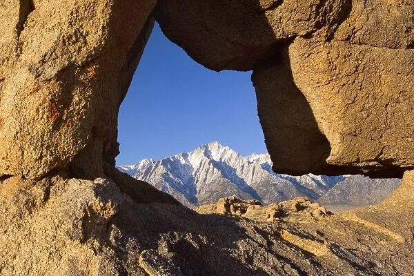 Boot Arch - Lone Pine, one of the snow-capped mountains of the Sierra Nevada, framed by granite arch in the shape of a boot - Alabama Hills Recreation Area, California, USA