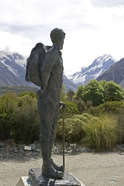 Bronze statue of Sir Edmund Hillary against snow capped mountains and forested slopes in Aoraki Mount Cook National Park. This spectacular wilderness area in South Island New Zealand has now been designated a World Heritage Site