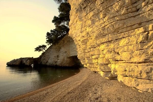 Calm bay with chalk cliffs and gravel beach Gargano Peninsula, Italy