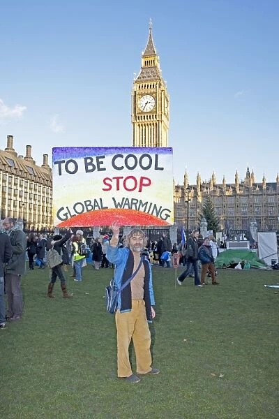 Campaigner with banner Be cool stop global warming