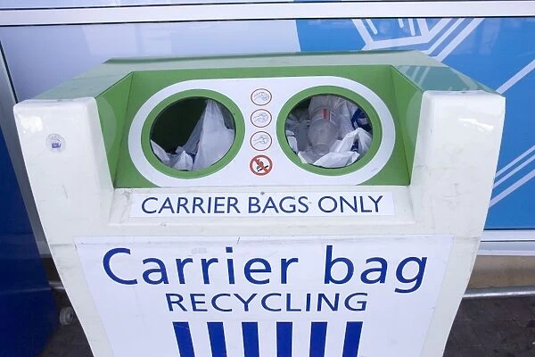 Carrier bag recycling container outside Tesco food store for disposing of plastic bags. Tesco does not charge customers for plastic carrier bags but has recently changed to using biodegrradable plastic