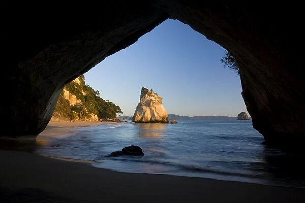 Cathedral Cove by erosion artfully sculpted rock formation seen through a natural rock arch at Cathedral Cove Cathedral Cove, Coromandel Peninsula, North Island, New Zealand