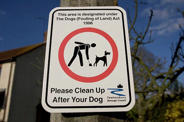 Please clean up after your dog sign, UK - it is now obligatory to clean up dog mess and this sign on a lamp post reminds dog walkers in Woodmancote, Gloucestershire