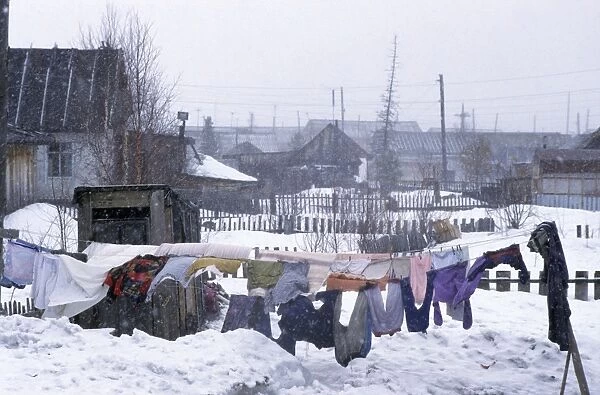Clothes drying in snowfall, Siberia A typical scene in Krasnoselkup settlement, yards and houses covered in snow, clothes normally dryed outside all year round (in winter - longer); winter; North Tumen region, river Taz bank