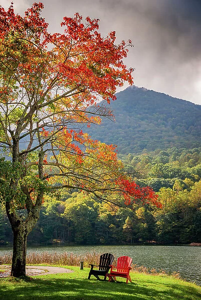 Colorful chairs on the banks of the lake, Peaks Of Otter, Blue Ridge Parkway, Smoky Mountains, USA. Date: 05-10-2018