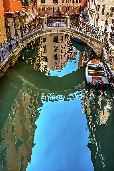 Colorful small canal and bridge creates beautiful reflections in Venice, Italy Date: 26-01-2021