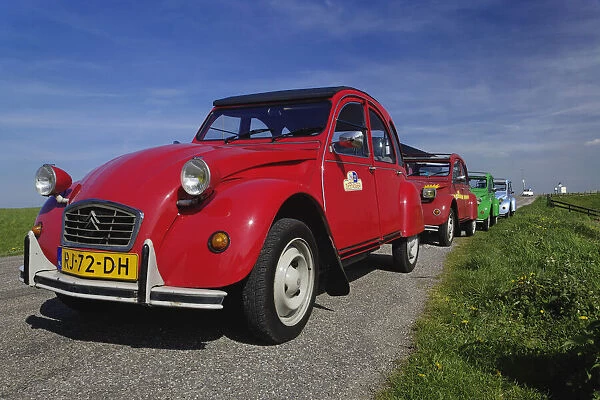 DDE-90033011. Small old cars along dike or levee, Holland, Netherlands Date: 11 / 11 / 2005
