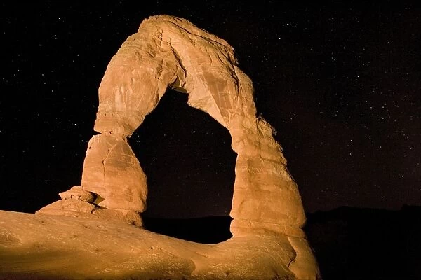 Delicate Arch - probably the best-known natural arch in the USA. Arches National Park, Utah. Photographed after dark to show starry sky