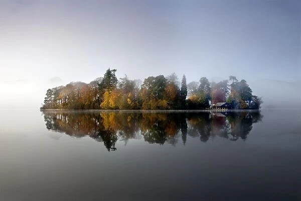 Derwent Island - autumn reflections in derwent water on a calm misty morning - Lake District - England