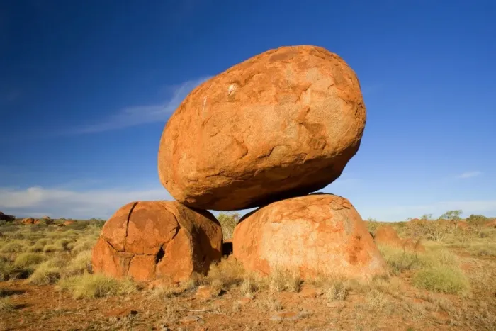 Framed Print : Devils Marbles - a balanced rock of red granite is situated on top of two boulders - Devils Marbles Conservation Area, Northern Territory, Australia Framed Print : Devils Marbles - a balanced rock of red granite is situated on top of two boulders - Devils Marbles Conservation Area, Northern Territory, Australia