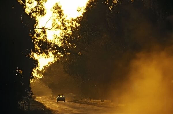 Dirt road with car at sunset near Mildura, Victoria, Australia JLR00529