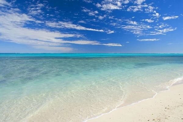 Dream Beach - white sandy beach, clear turquoise coloured water and a deep blue sky combine to a perfect beach. The shallow reef is recognizable as darker blue spots in the ocean