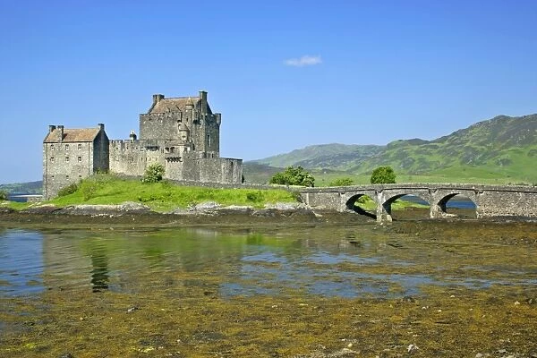 Eilean Donan Castle view of castle located in Loch Duich at low tide on a sunny day Kyle of Lochalsh, Highlands, Scotland, UK
