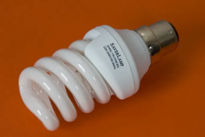 Framed Print : Energy efficient light bulb or Saverlamp, UK - Compact fluorescent energy efficient spiral light bulb or Saverlamp uses 80% less energy than traditional bulbs and last up to 10 times longer, UK