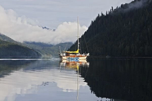 Estuary - with boat surrounded by temperate rainforest. Khuzemateen Grizzly Bear Sanctuary - British Colombia - Canada
