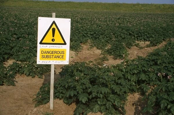 Farming - sign warning to keep out of field. Crops sprayed with dangerous substance