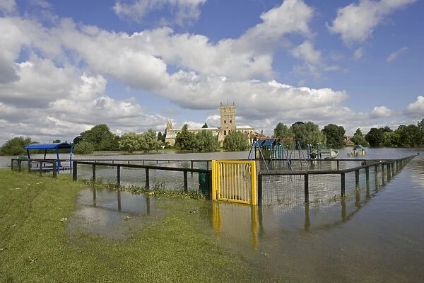 Flooded childrens playground with Tewkesbury Abbey inundated by unprecedented flooding of the Rivers Severn and Avon July 2007 Gloucestershire UK